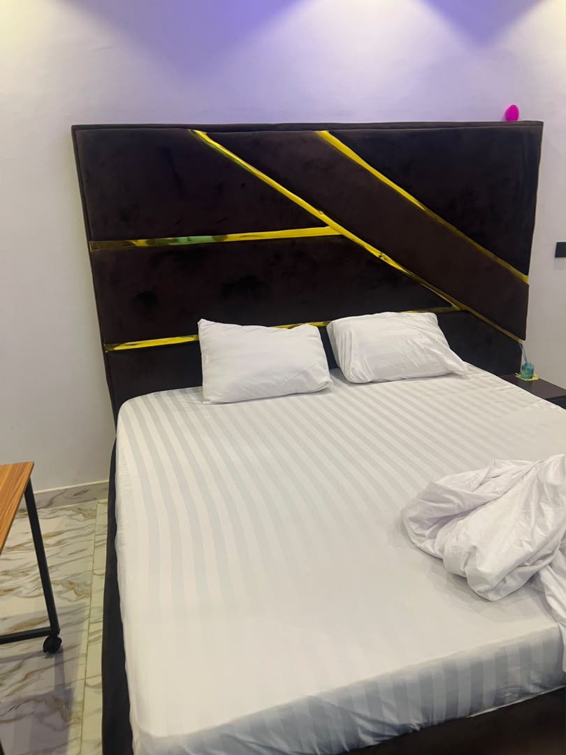 Close-up of velvet headboard with gold diagonal stripes