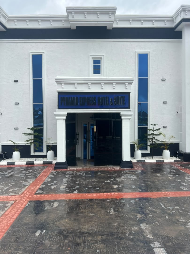 Pyramid Express Hotel & Suite white facade with blue signage
